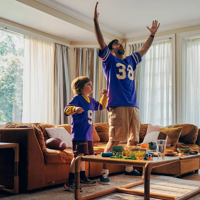 Family watching football in a living room